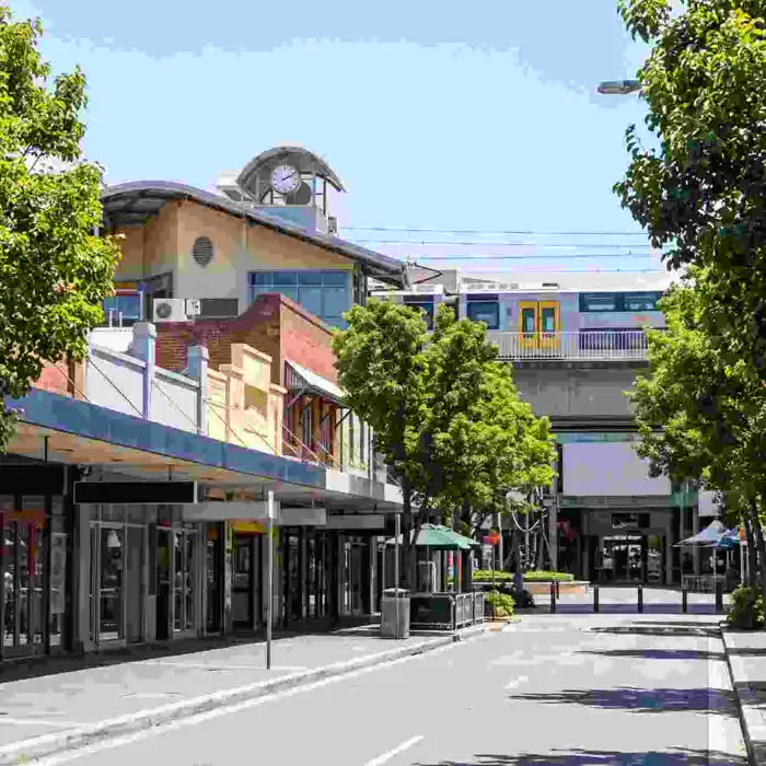 Hornsby town centre street with clock tower and train overpass